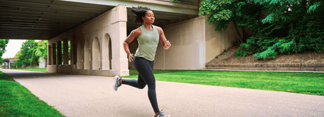 Happy woman showing good running shoes make a difference